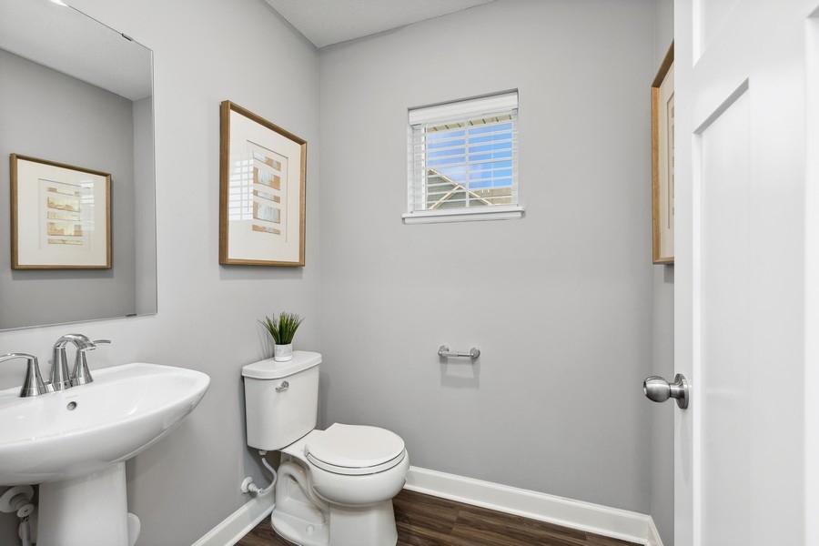 Powder bath located on main level. (Photo of decorated model, actual home's finishes may vary slightly)