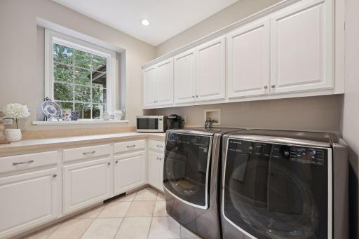 Main floor designated laundry room with frontload LG washer/dryer set. Doubles for kitchen storage & extended counter spaces. Conveniently located as you enter from the garage.