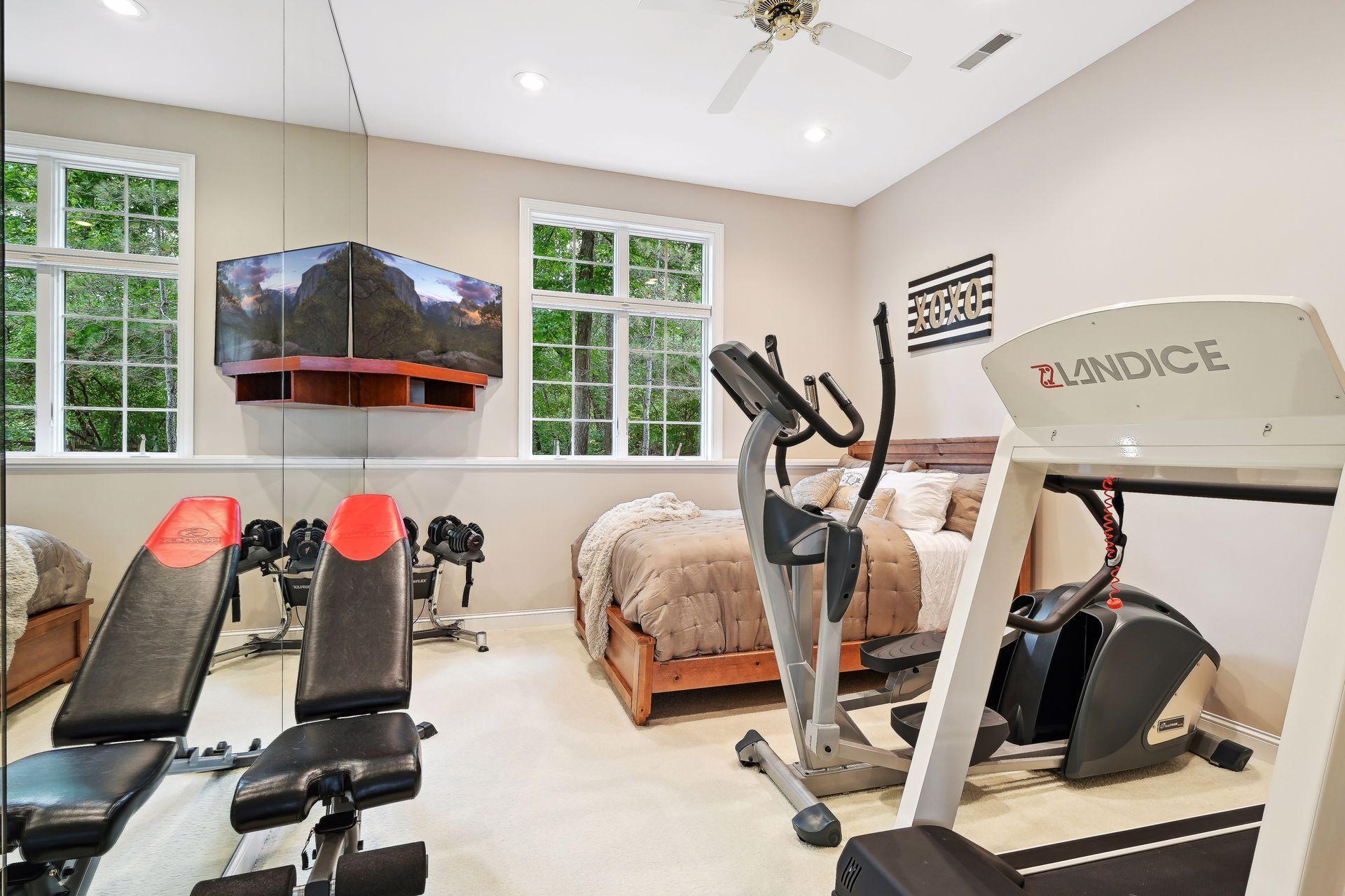 Bedroom #5 in Lower-Level. Flex Room/Workout Room. Love to golf? Modify this room - there is space with 11' ceiling height to accommodate a new golf simulator for year-round enjoyment.