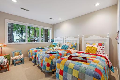 Bedroom #4 in Lower-Level. French door entry, fantastic lake views & a huge walk-in closet/room. Every lake home needs a "bunkhouse" for the kids to gather.