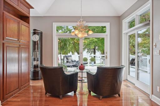 Informal Dining Room with dual patio doors to wrap around deck. Currently, this is a favorite sitting area for morning coffee & reflection. Notice the steep vaulted ceilings and built-in storage.