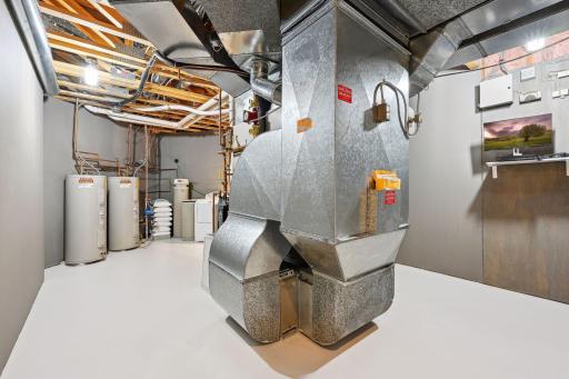 Meticulously maintained utility room & 2nd laundry. Survailiance system provides homeowner with heightened sense of safety whether home or away. Dual AC units, oversized furnace, dual water heaters, softener, air exchanger, in-floor heat.