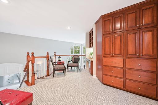 Upper-level landing with second officing space & built-in linen storage. Entrance to two spacious guest suites. New carpeting.