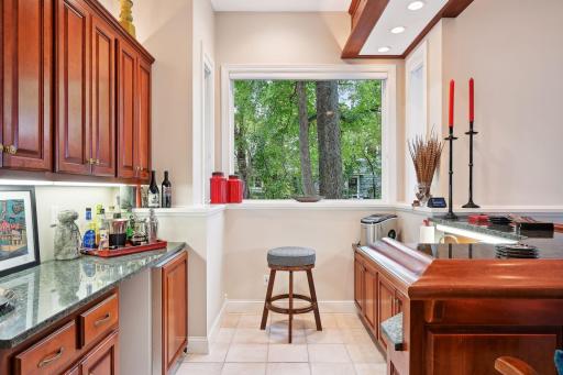 Wet bar including mini-fridge & plenty of storage for anything party-related! Seating for four around the bar plus a bar-tender.