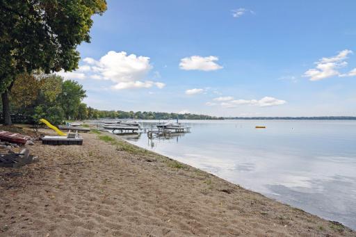 Pristine sandy beach stretches 169' along the shoreline with sand bottom reaching out into the bay. The gentle slope makes for ideal wading & swimming conditions. Dock, floating dock & slide are all association maintained.