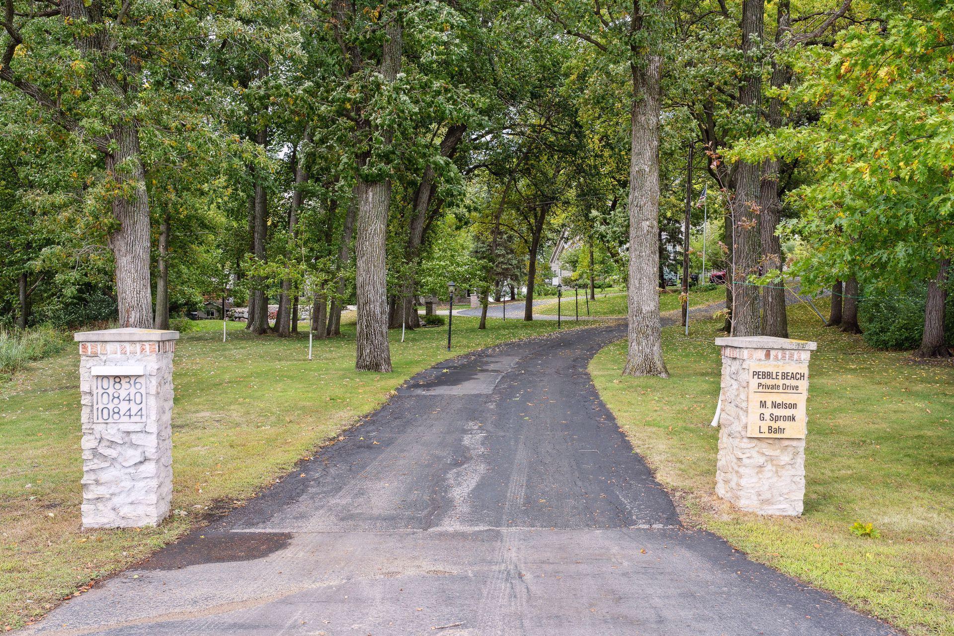 Customized pillars greet you at the entrance of the long private driveway. Lamps illuminate the way around the circular driveway to each of the three residences. Homes are nestled in the trees, far away from the curious eyes of traffic passing by.