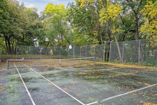 Benefits of the shared association include this full-size tennis court! High-fence was installed to contain balls & equipment. Versatile court will be happily utilized by "athletes" of all ages & sport preferences.