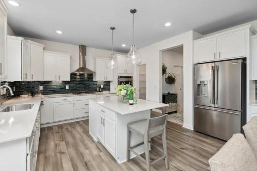 Imagine preparing a wonderful meal for dinner in this kitchen or entertaining friends and family over the weekend! (Photo of decorated model, actual home's finishes may vary slightly)