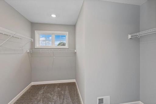 The owner's suite features an incredible walk-in closet. (Photo of decorated model, actual home's finishes may vary slightly)