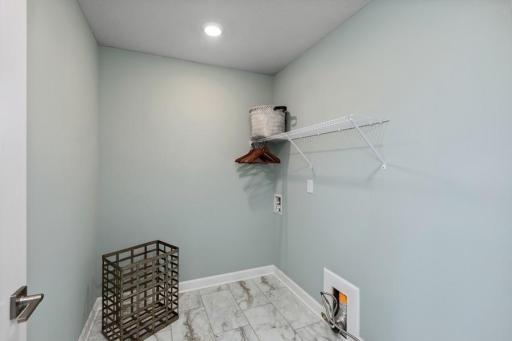 Centrally located on the upper level, along with the four bedrooms, this laundry room is sure to provide the ultimate convenience. (Photo of decorated model, actual home's finishes may vary slightly)