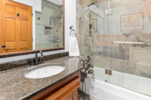 The first full bath on the UL features gorgeous granite counters and a beautiful shower/tub