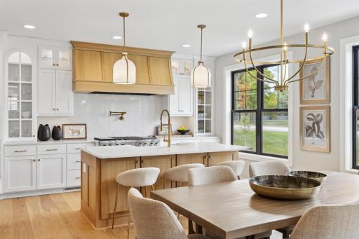 Architectural kitchen with gas, induction and sous vide range top, convenient pot-filler, custom cabinetry and wall of windows for a sun-filled kitchen. Enjoy cooking & baking & entertaining with family & friends in this stunning Kitchen.