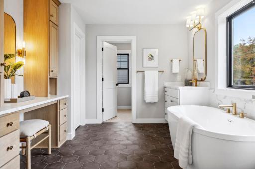 This Spa-like bathroom features freestanding tub, make-up vanity, large walk-in closet, and oversized walk-in Shower with rain shower head, and beautiful tilework throughout.