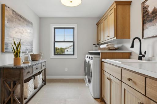 Our large, convenient, sun-filled 2nd floor laundry room has plenty of cabinet storage and workspaces, makes washing clothes enjoyable!