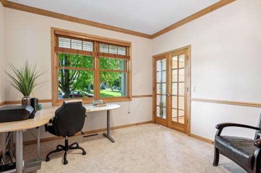 Main floor office with french door and overlooks front yard.