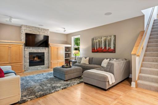 Large family room with wood floors, built-ins and gas fireplace