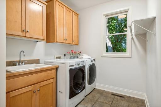Laundry room located between garage and kitchen. Plus closet and extra storage.