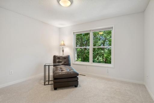 4th upper level bedroom with views of the front of backyard & trails.