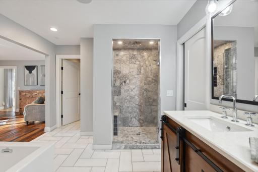 luxurious master marble tile shower with rain head