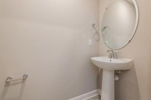 Conveniently located main level powder bath easily accessible from the entryway. (Photos are not of actual home. Actual home will be similar. Some colors and features may vary.)