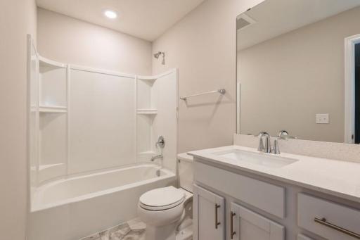 Stunning secondary bathroom with plenty of room for everyone to get ready. (Photos are not of actual home. Actual home will be similar. Some colors and features may vary.)