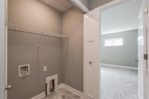 Upper Level Laundry Closet! *Photos are of another home, colors and finishes may vary.