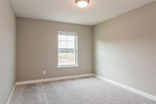 Each of the home's secondary bedrooms on the upper level come perfectly sized and all feature a spacious closet. *Photos are of another home, colors and finishes may vary.