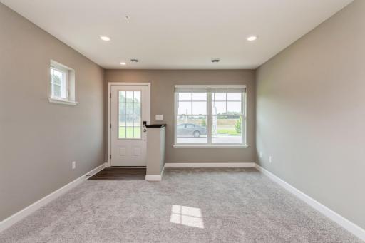 Lovely and inviting great room that features large windows for plenty of natural light. *Photos are of another home, colors and finishes may vary.