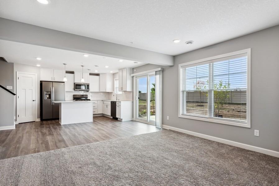 The large windows and sliding door brings in so much natural sunlight! (Photo of a completed home, actual home's finishes may vary slightly)