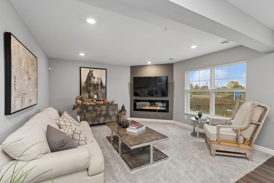 The modern fireplace featured in the great room is an extraordinary room accent. Enjoy the warmth of this gas fireplace as you relax. (Photo of decorated model, actual home's finishes may vary slightly)