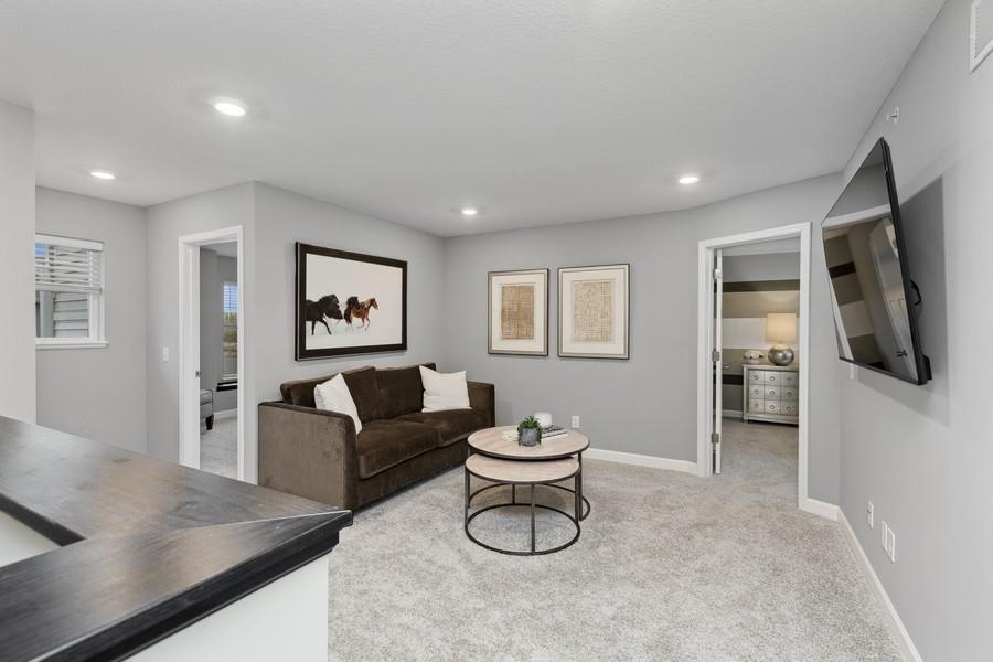 Located on the upper level, this perfectly sized living space has enough room for a desk, television and seating for all. (Photo of decorated model, actual home's finishes may vary slightly)