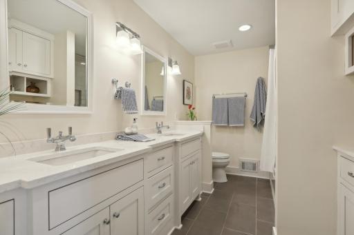 Renovated guest bath is beautifully appointed. Quartz topped elevated duo sinks and oversized tub.