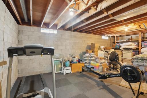 Exercise/ storage room. If you need another bedroom, a wine cellar, craft room, a place to wax your skis or work on your bikes this is it. Back wall with shelves could easily become a west facing window.