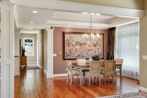Hand scraped cherry hardwood flooring with French antiquing. Lots of architectural detail in this home with the ceiling detail and columns.