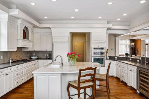 Center island has a Miele dish washer, Kohler smart divide sink, Grohe faucet and 3/4 hsp garbage disposal.