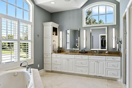 The owners' bath was recently updated with new faucets, mirrors and lights. Flooring and counter top are marble. To the right are a private water closet and a steam/shower room.