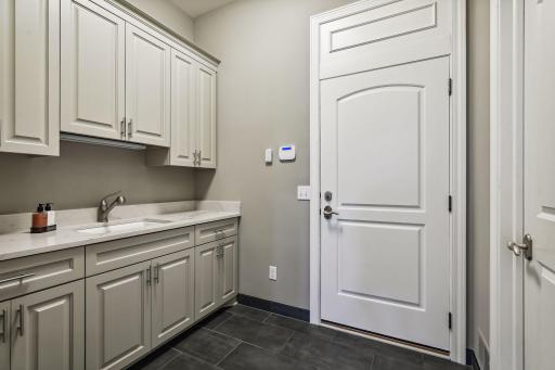 The mud room was recently updated with new flooring and paint. Walk-in closet is adjacent.
