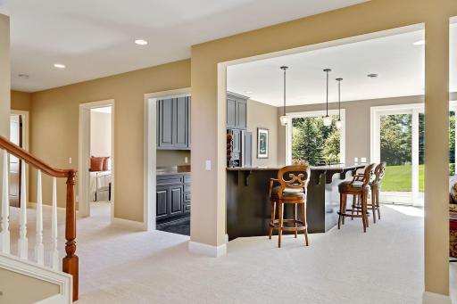 Lower level wet bar was recently remodeled with darker, lacquered cabinets and new ceramic tiled flooring. Entire lower level has in-floor hot water heat. Newer carpet throughout the lower level.