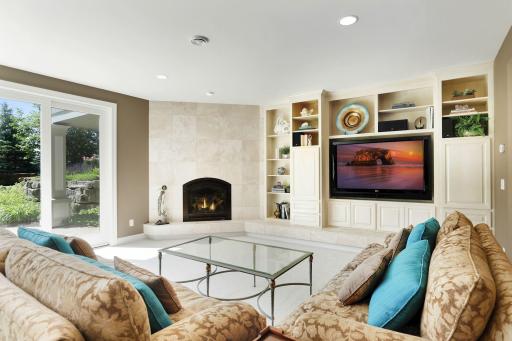 Limestone surround on the fireplace and below the custom cabinets.