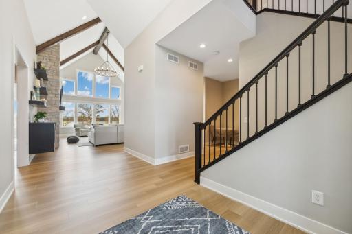 As you enter the front door, you are greeted by soaring vaults, and views of the lake