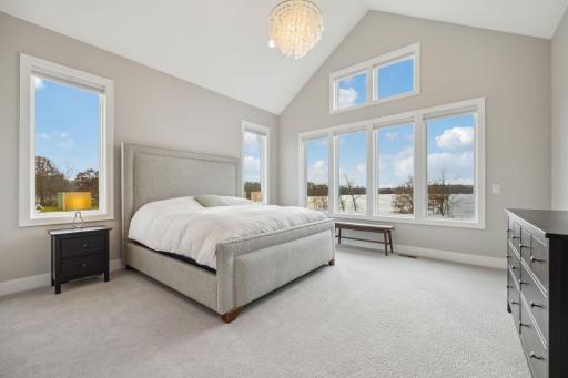 Vaulted primary bedroom overlooking the lake