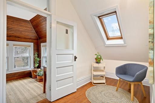 Transforming the hallway into a delightful sanctuary, a thoughtfully placed nook is graced by a skylight, infusing the space with natural light and creating an inviting alcove for a moment of respite or a touch of indoor greenery.