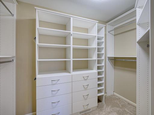 Custom closet inserts for efficient use in the walk-in closet.