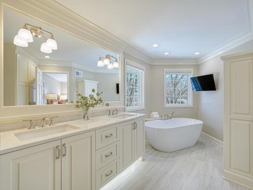 The custom renovated primary suite bath has separate tub and shower and heated floors!
