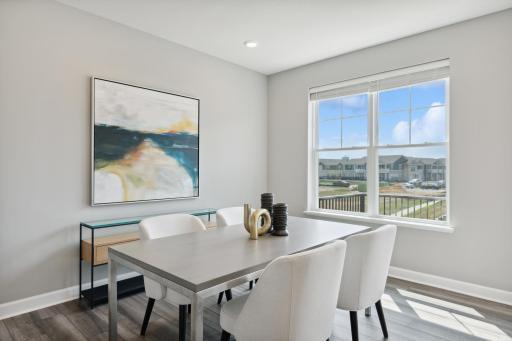Soaked in natural sunlight, the homes eat-in dining room has ample space for a dining table located in the heart of the home. (Photo of decorated model, actual home's finishes may vary slightly)