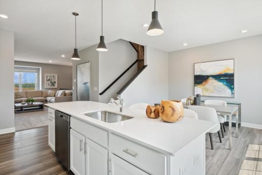 The open layout provides an optimal area to cook and entertain. (Photo of decorated model, actual home's finishes may vary slightly)