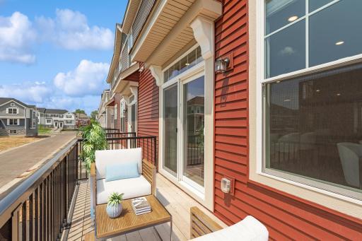 Relax, sunbath or gather on your balcony. Conveniently located adjacent to the dining and kitchen area, this outdoor oasis is delightful during all seasons. (Photo of decorated model, actual home's finishes may vary slightly)