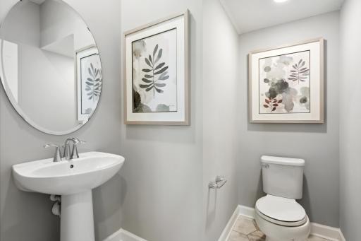 Powder bath conveniently located off the family room. (Photo of decorated model, actual home's finishes may vary slightly)