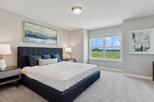 Find your retreat in this stunning owner's suite. (Photo of decorated model, actual home's finishes may vary slightly)