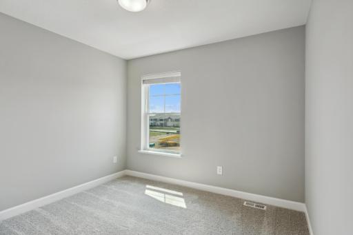 The second spacious secondary bedroom. (Photo of a completed home, actual home's finishes may vary slightly)